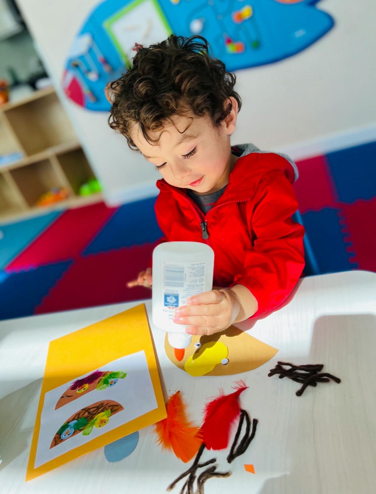 Child applying glue to a craft project