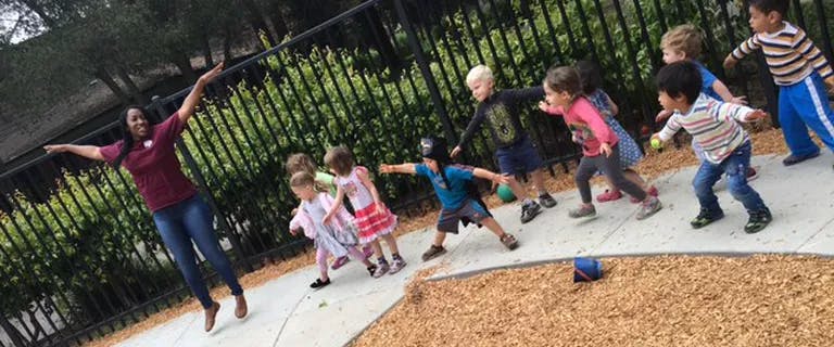 Person and multiple children playing outdoors