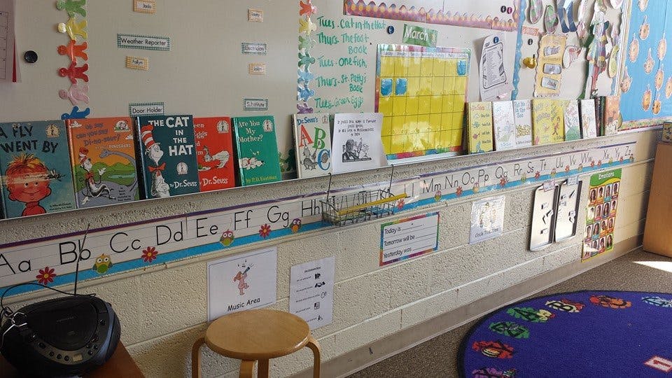 Children's books displayed on a shelf in a classroom