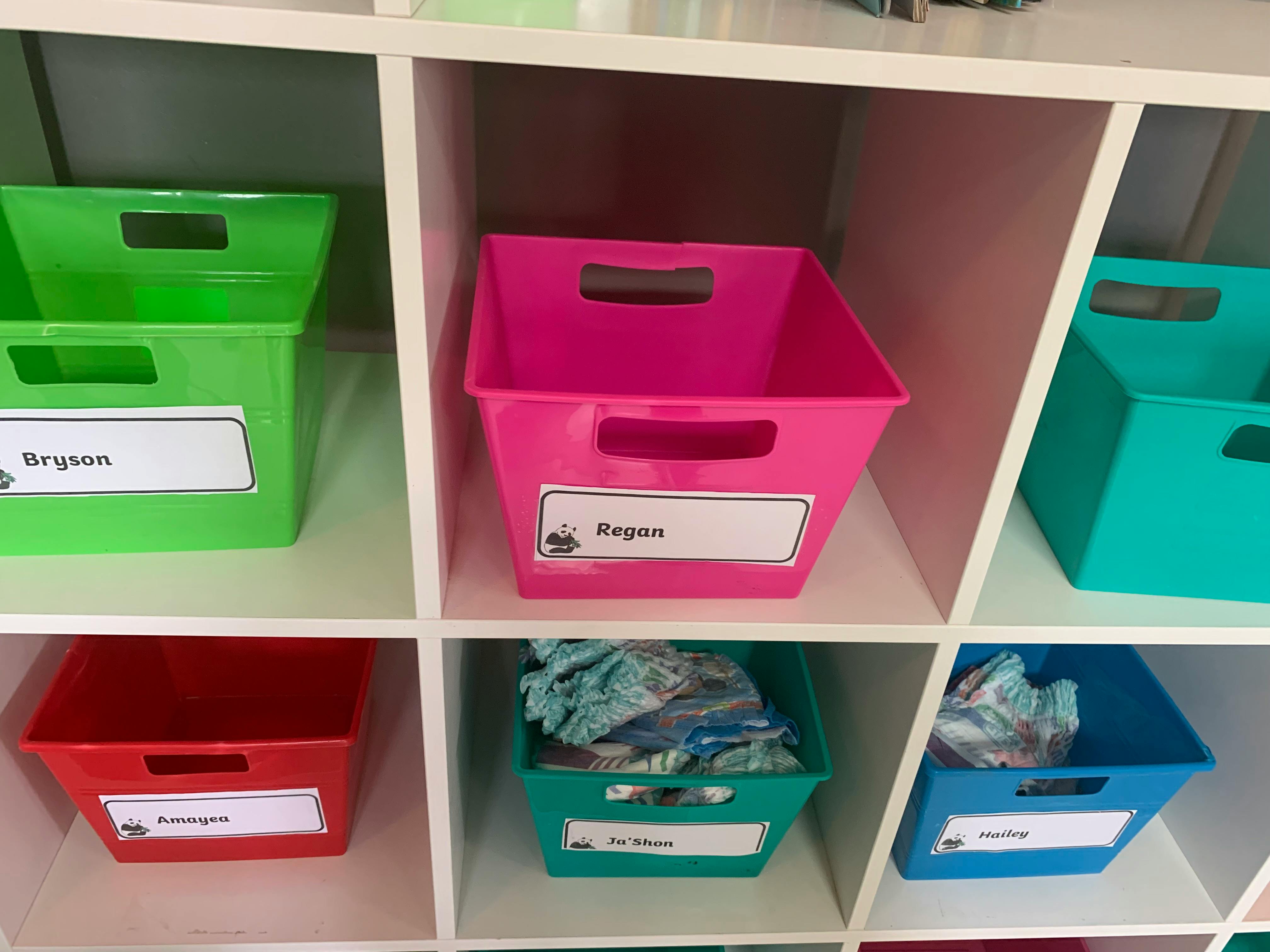 Shelves with colorful plastic bins, some with labels and contents