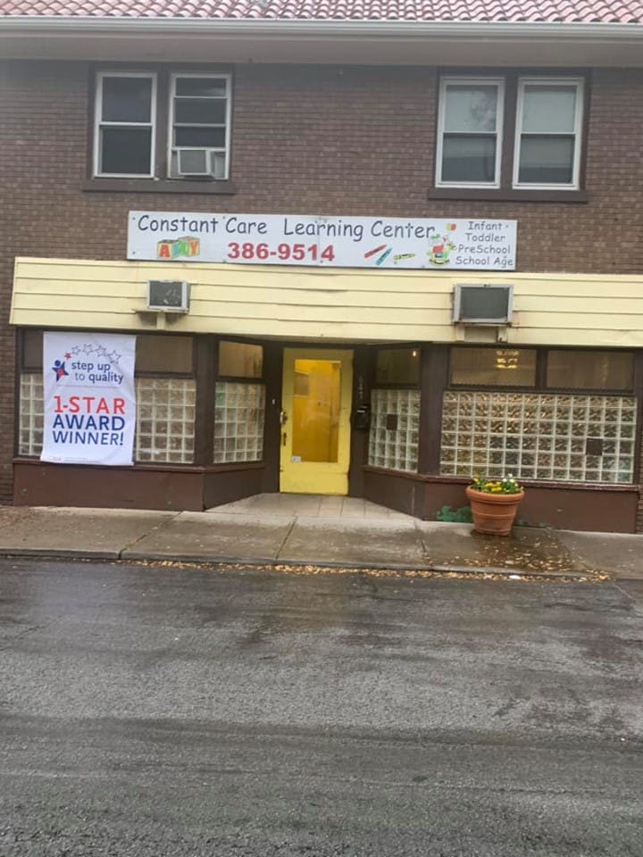 Constant Care Learning Center building with a sign and banner