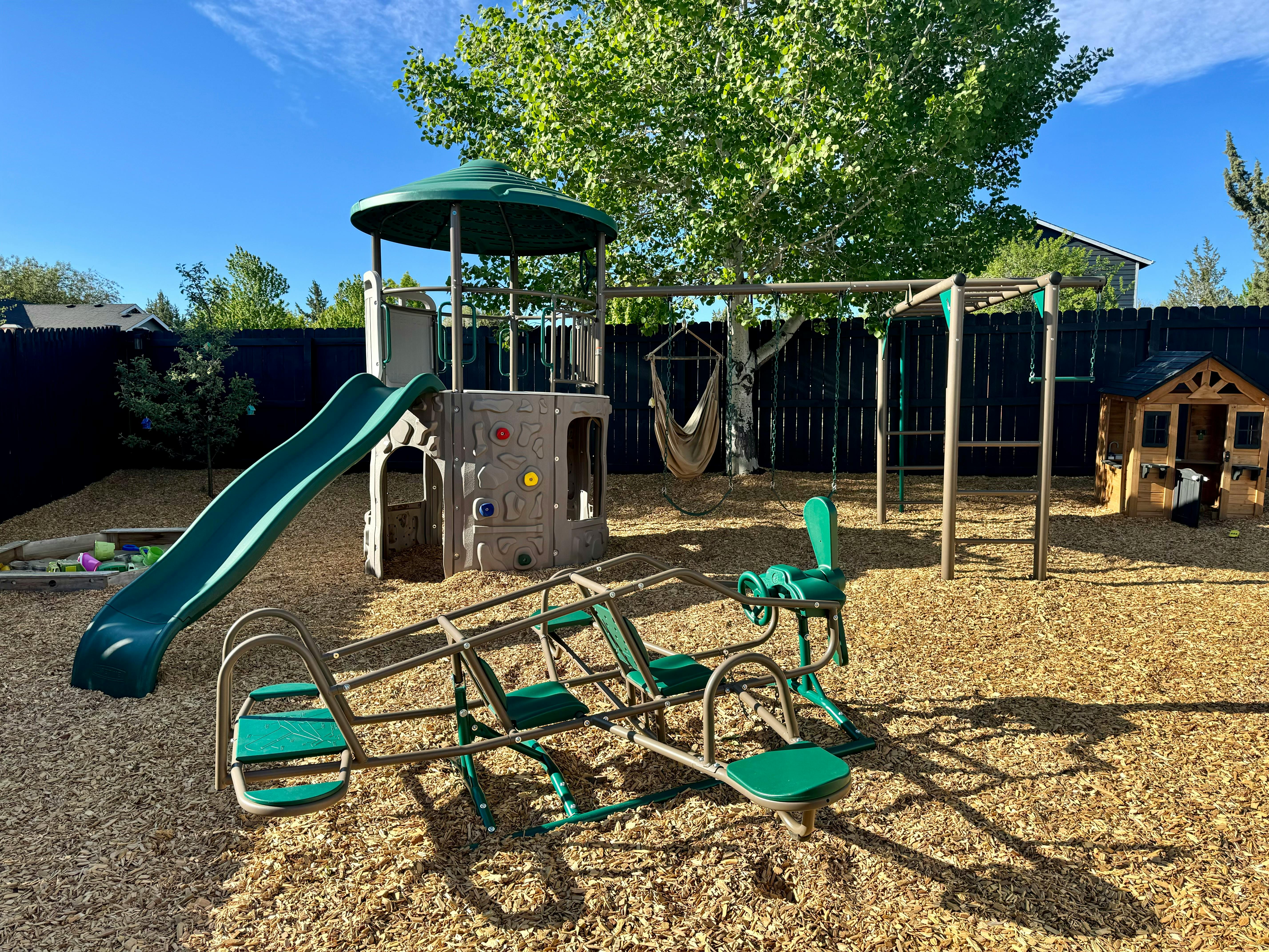 Playground with slide, swing set, and seesaw