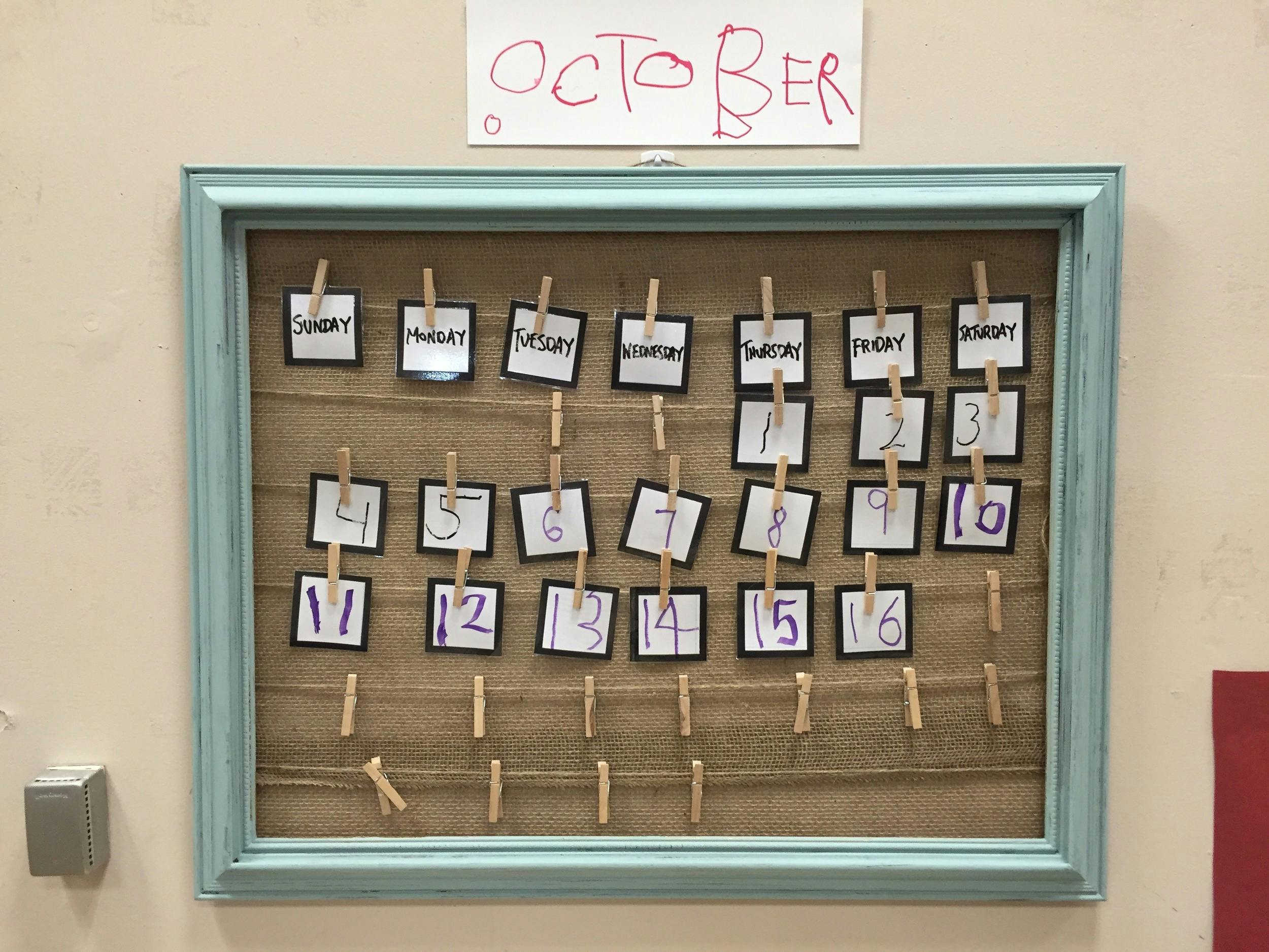 Framed calendar with "October" at the top, showing days of the week and dates