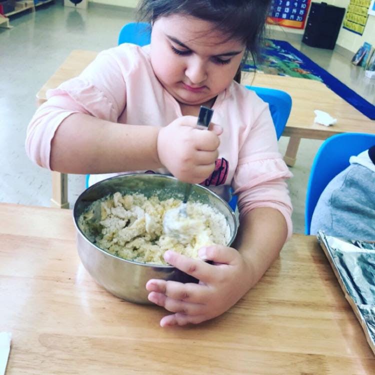 Child mixing ingredients in a bowl