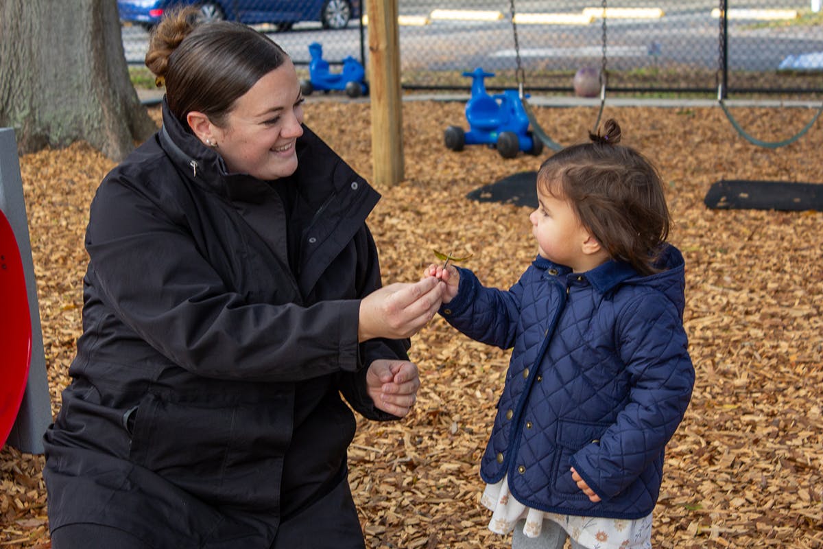 Person and child interacting on a playground