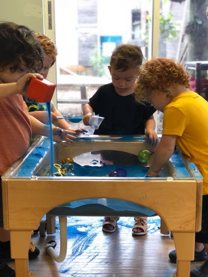 Children playing at a water table