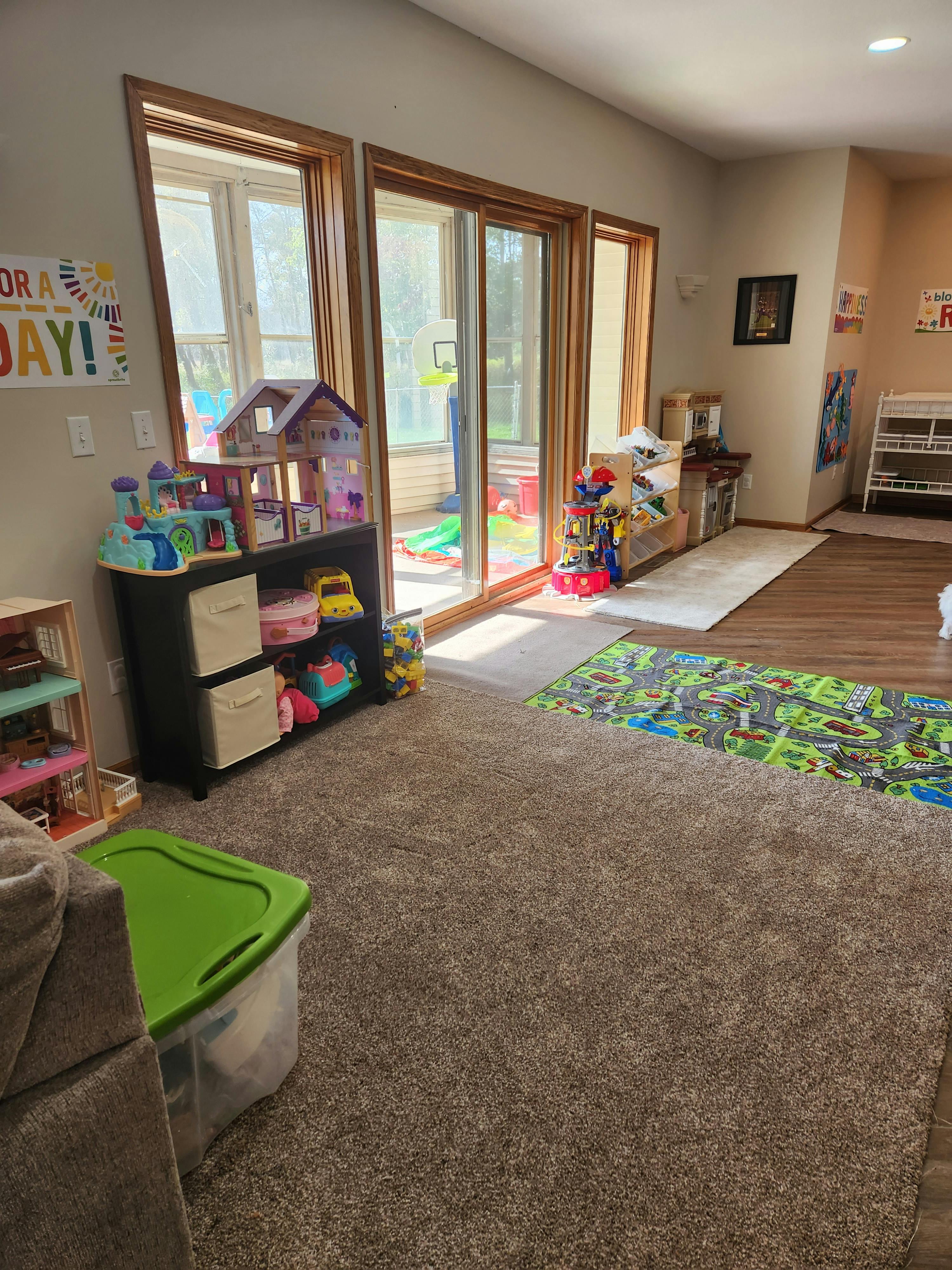 Playroom with toys, dollhouse, and sliding glass doors