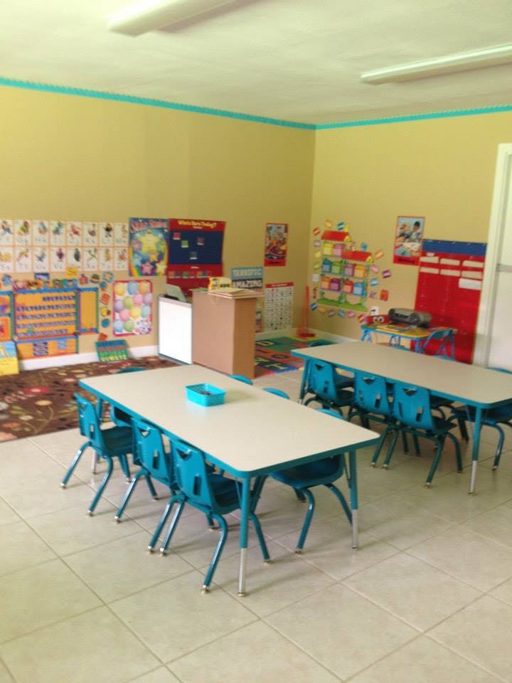 Classroom with small tables and chairs, decorated walls