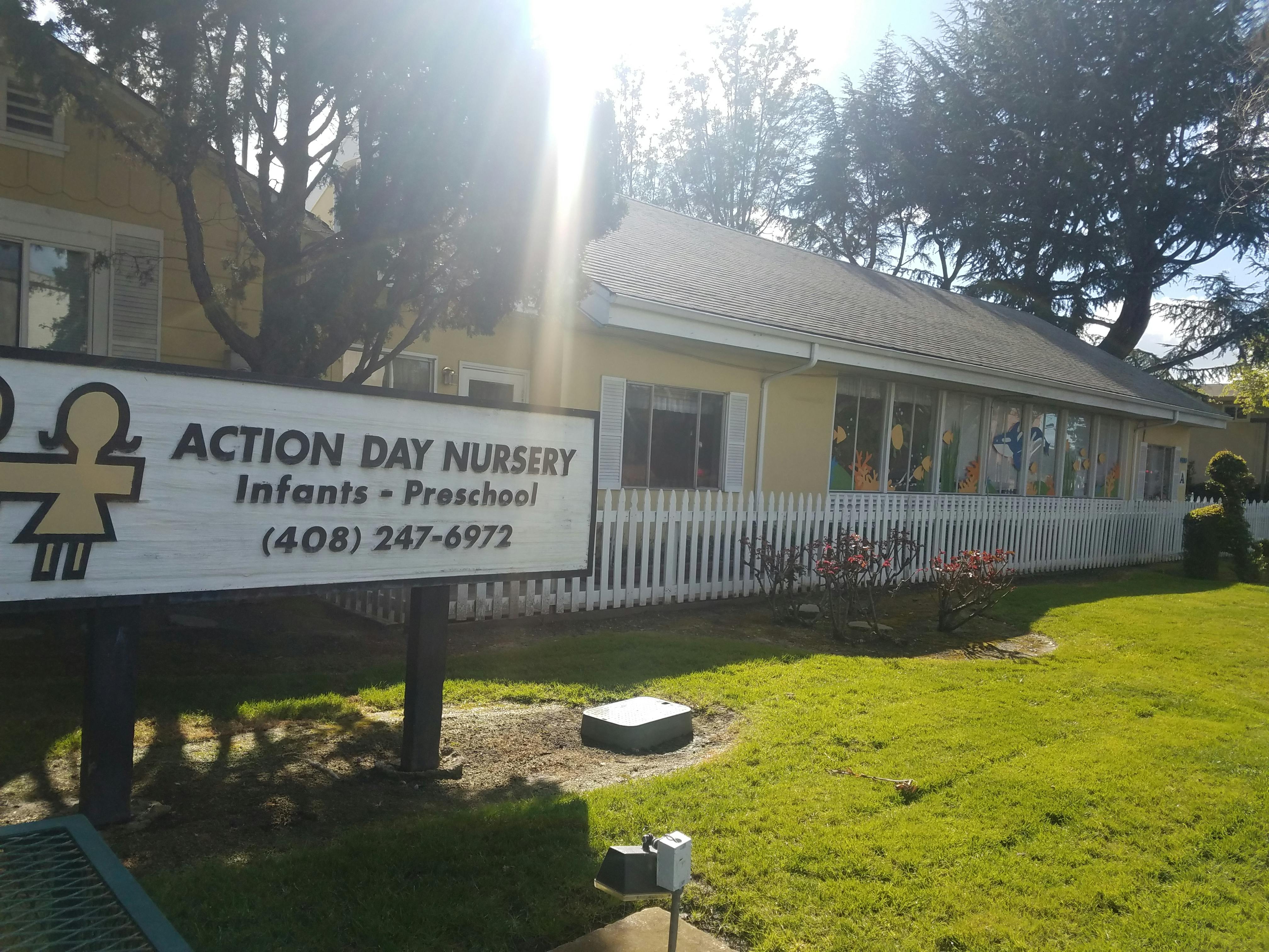 Action Day Nursery sign in front of a building