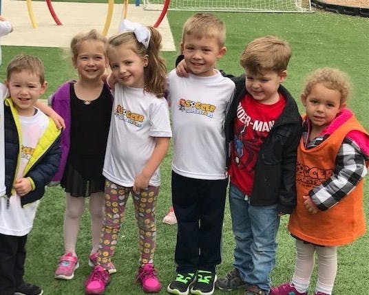 Group of children standing on artificial grass
