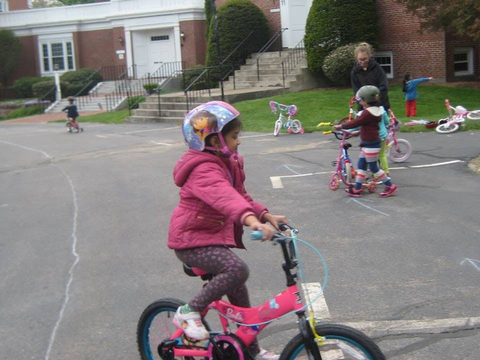 Child in a helmet riding a bicycle outdoors
