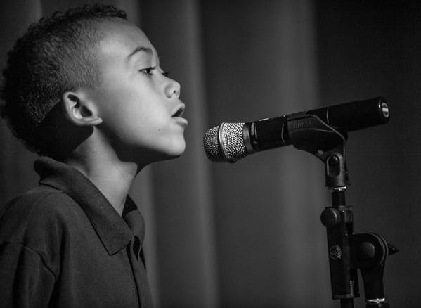 Child speaking into a microphone