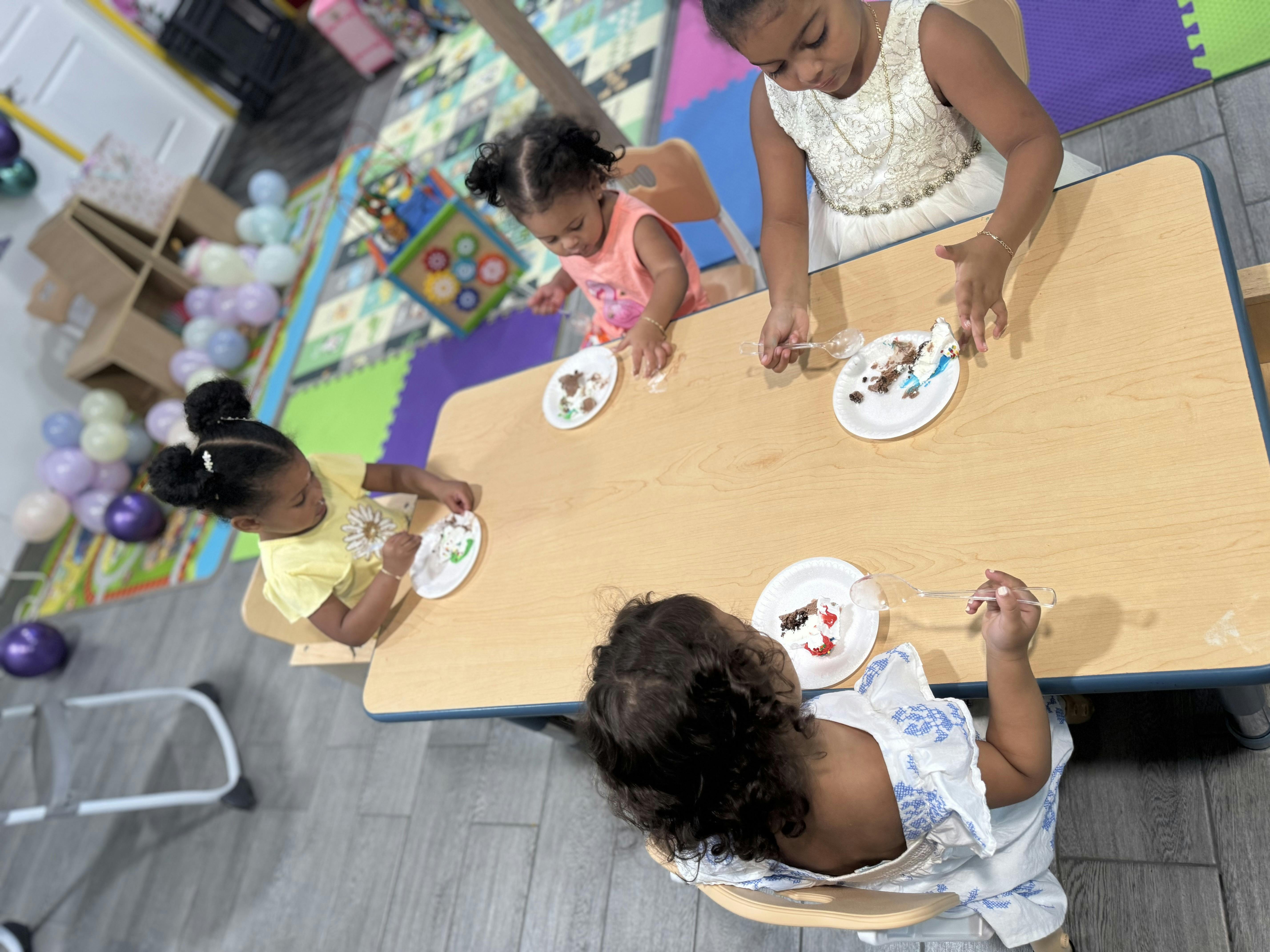 Children sitting at a table with plates