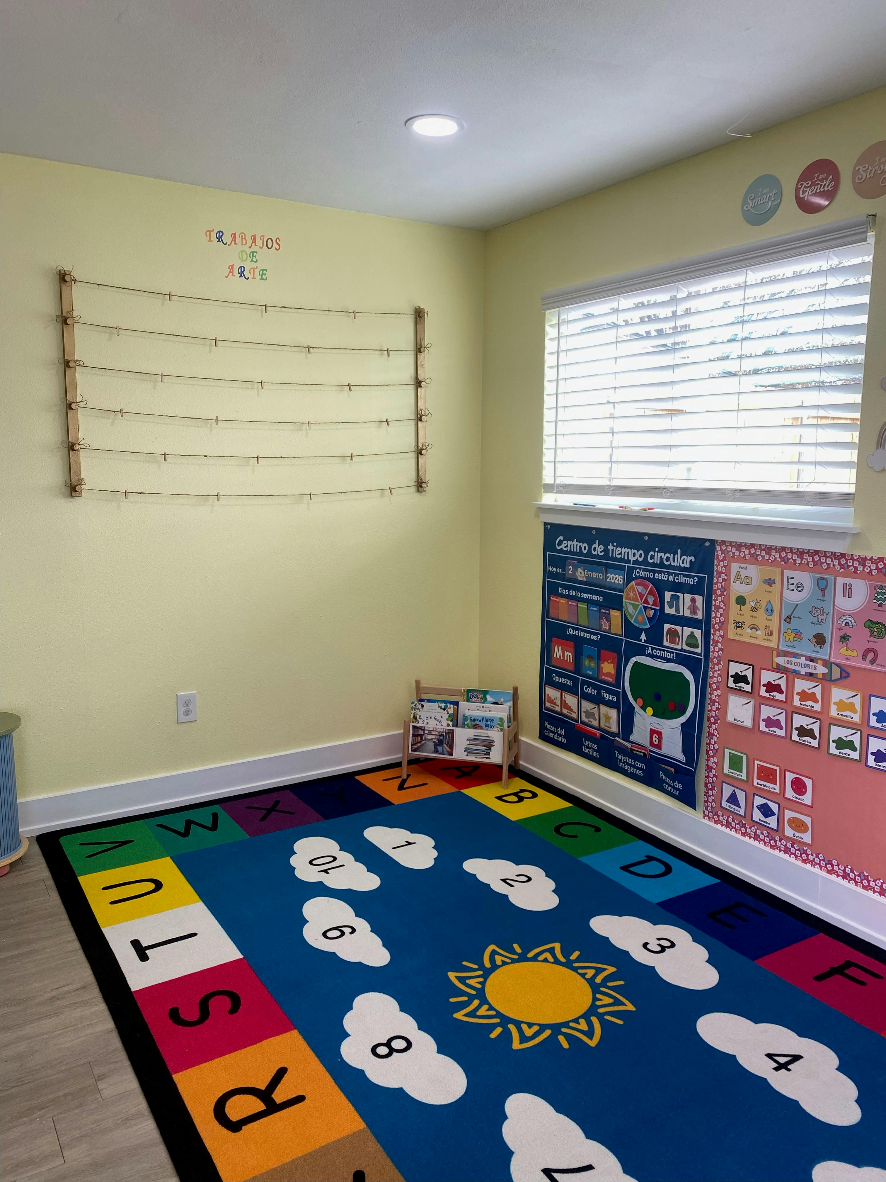 Classroom with a colorful rug, a bulletin board, and an art display