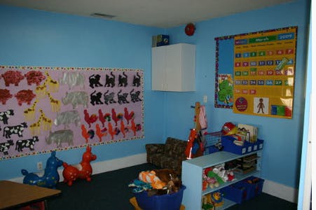 Classroom with blue walls, animal cutouts, and toys