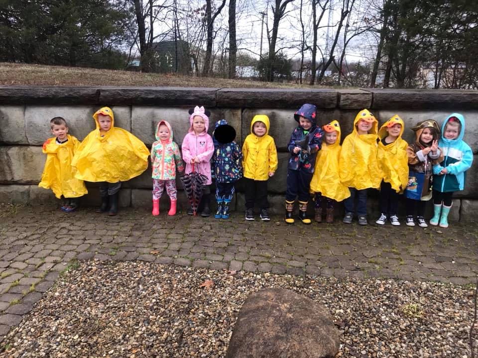 Group of children in rain gear standing outdoors