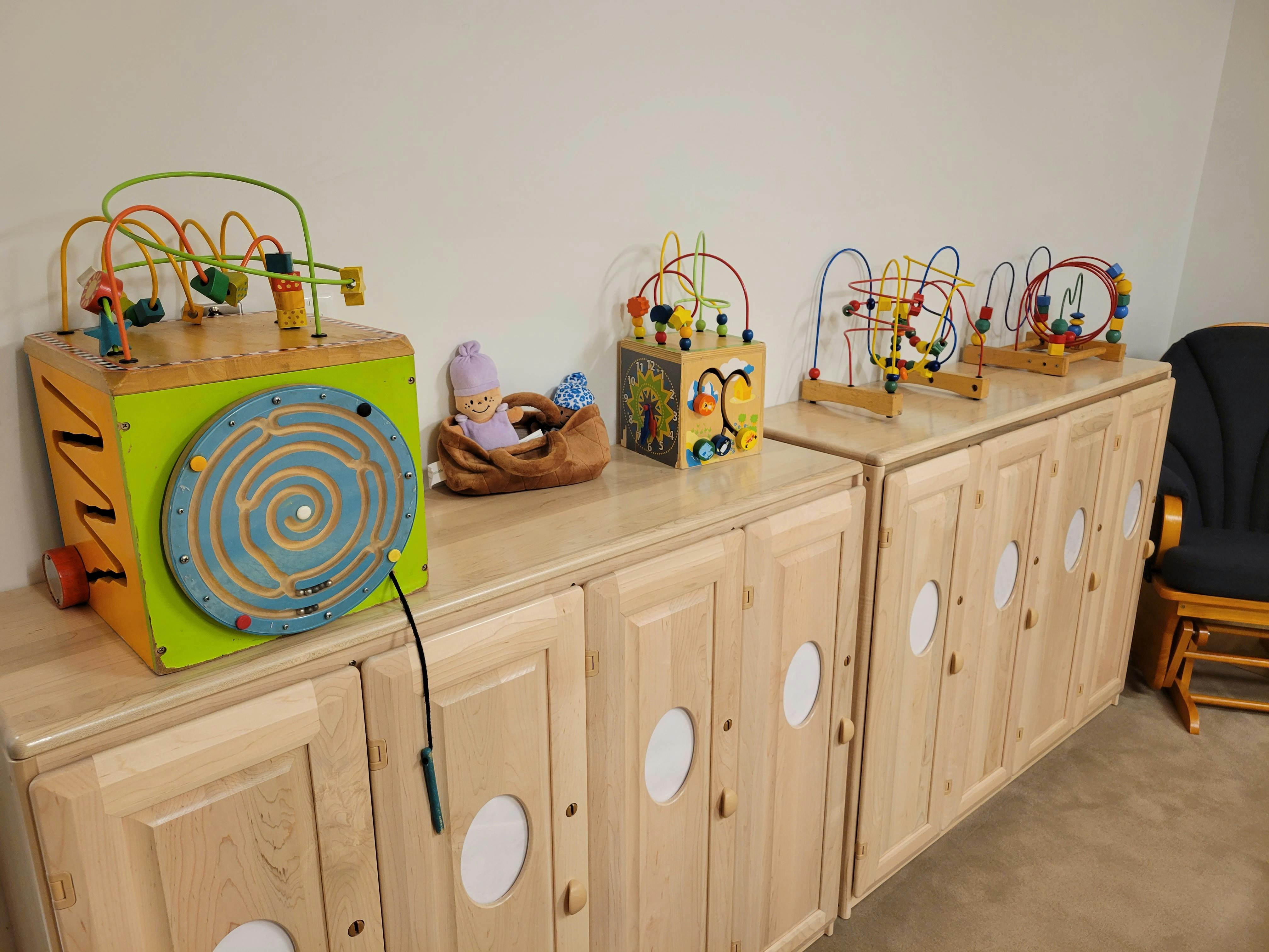 Children's activity toys on wooden cabinets