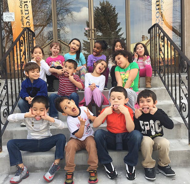 Group of children making silly faces on steps
