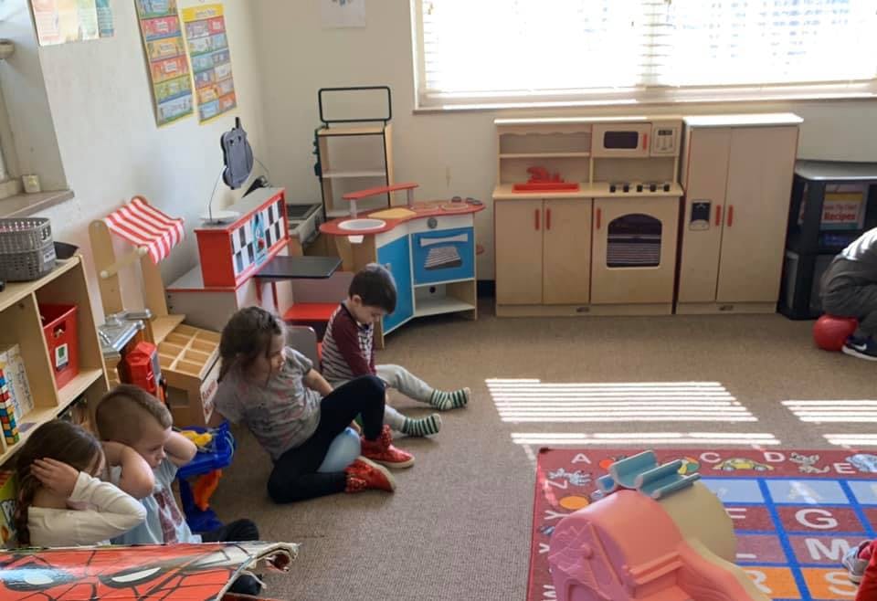 Children sitting on the floor in a classroom