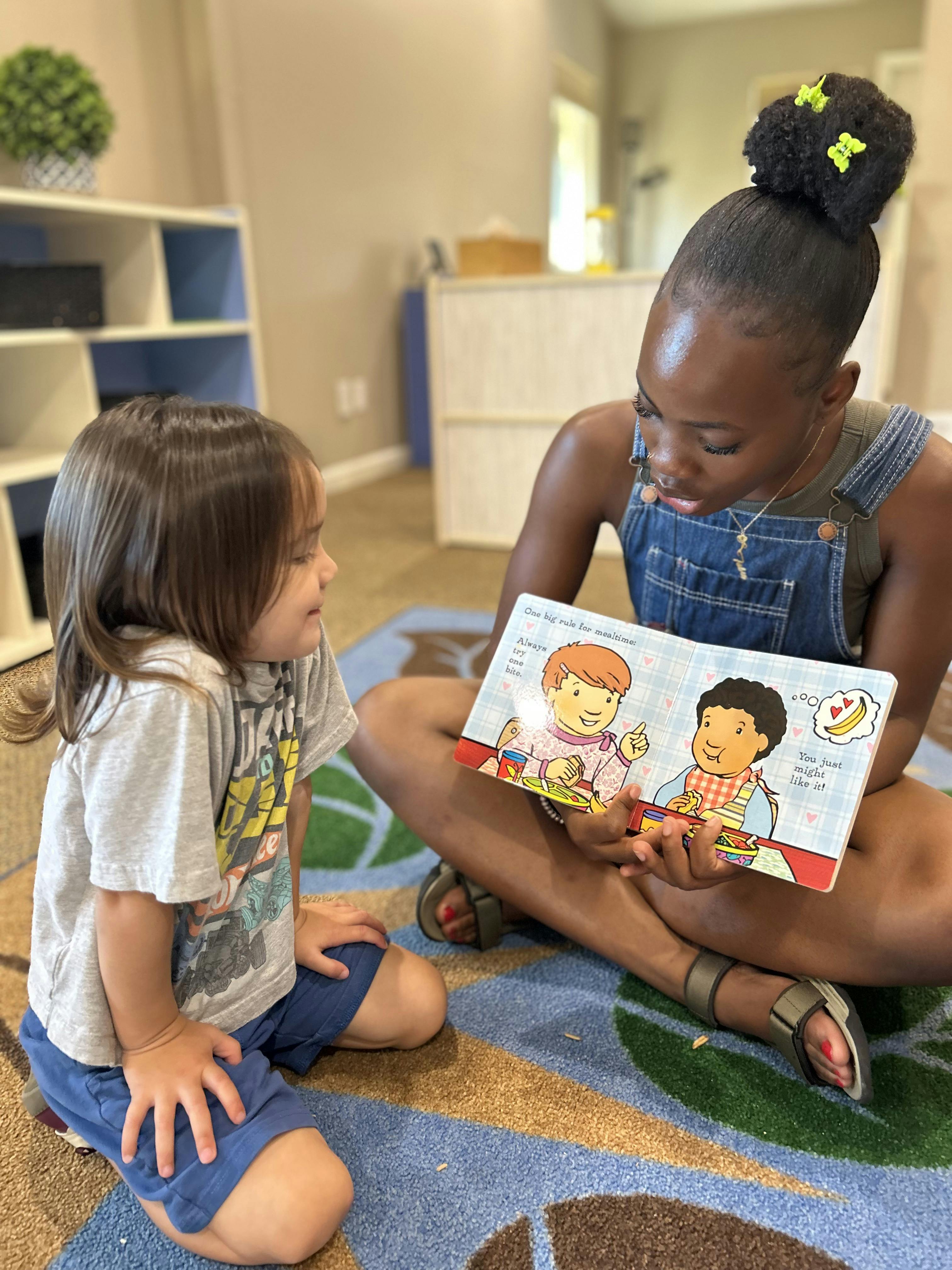 A person reading a book to a child