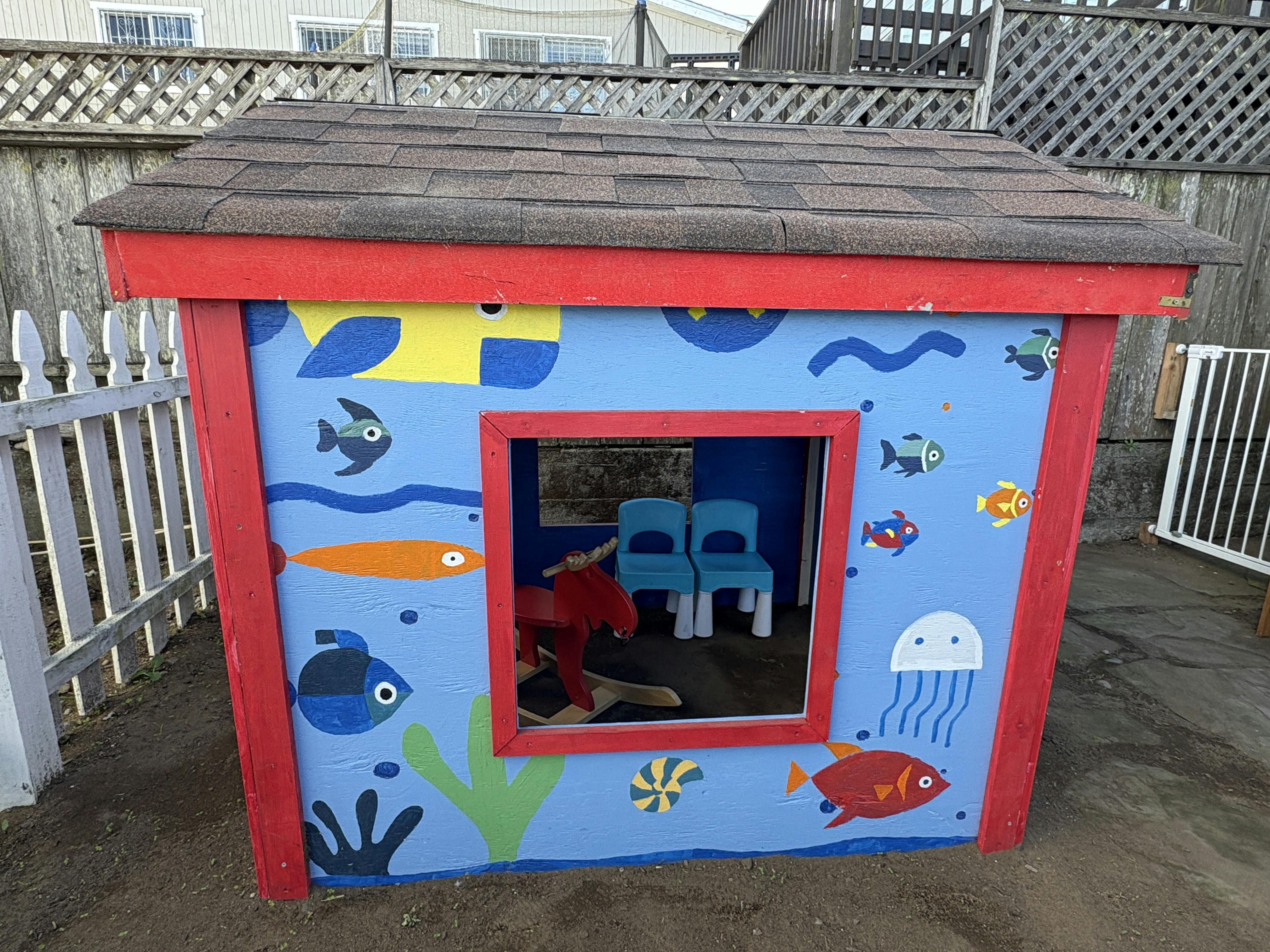 Playhouse with fish and jellyfish painted on the side