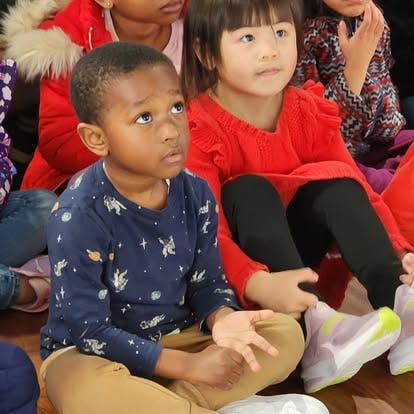 Two children sitting on the floor
