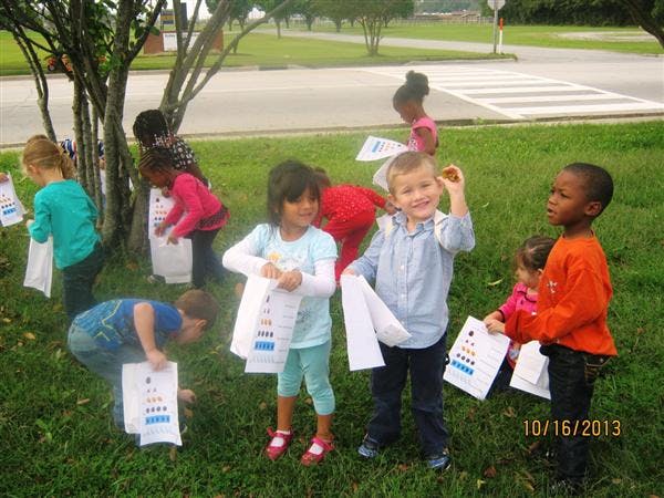 Children holding papers outdoors