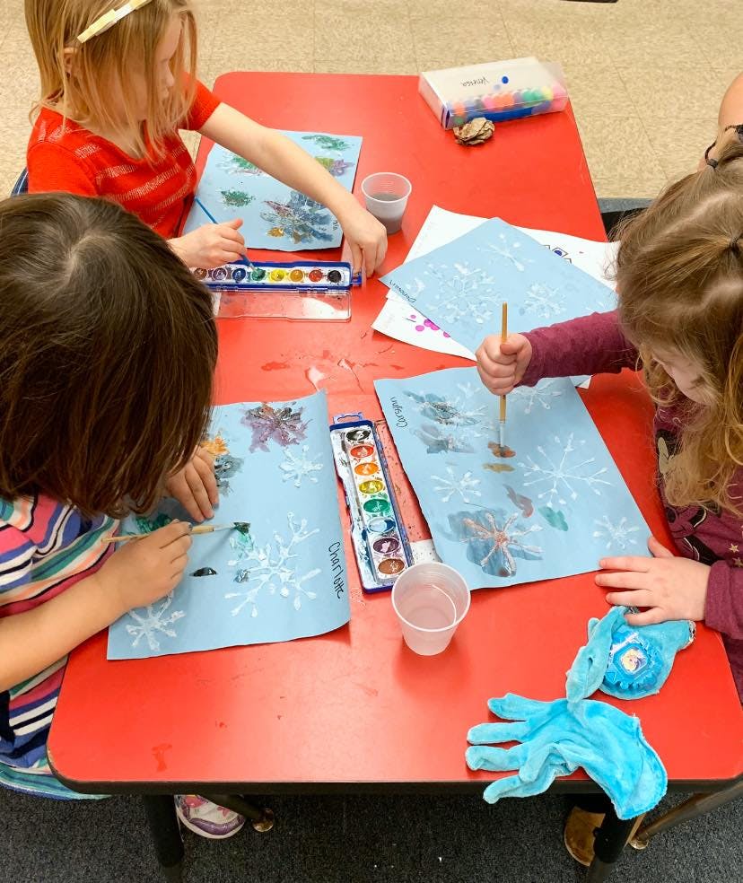 Children painting at a table