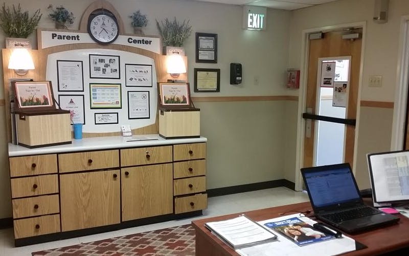 Parent Center counter with sign-in boxes, bulletin board, and desktop computer