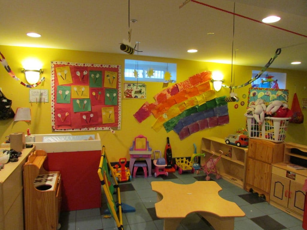 Playroom with yellow walls, colorful decorations, and children's furniture
