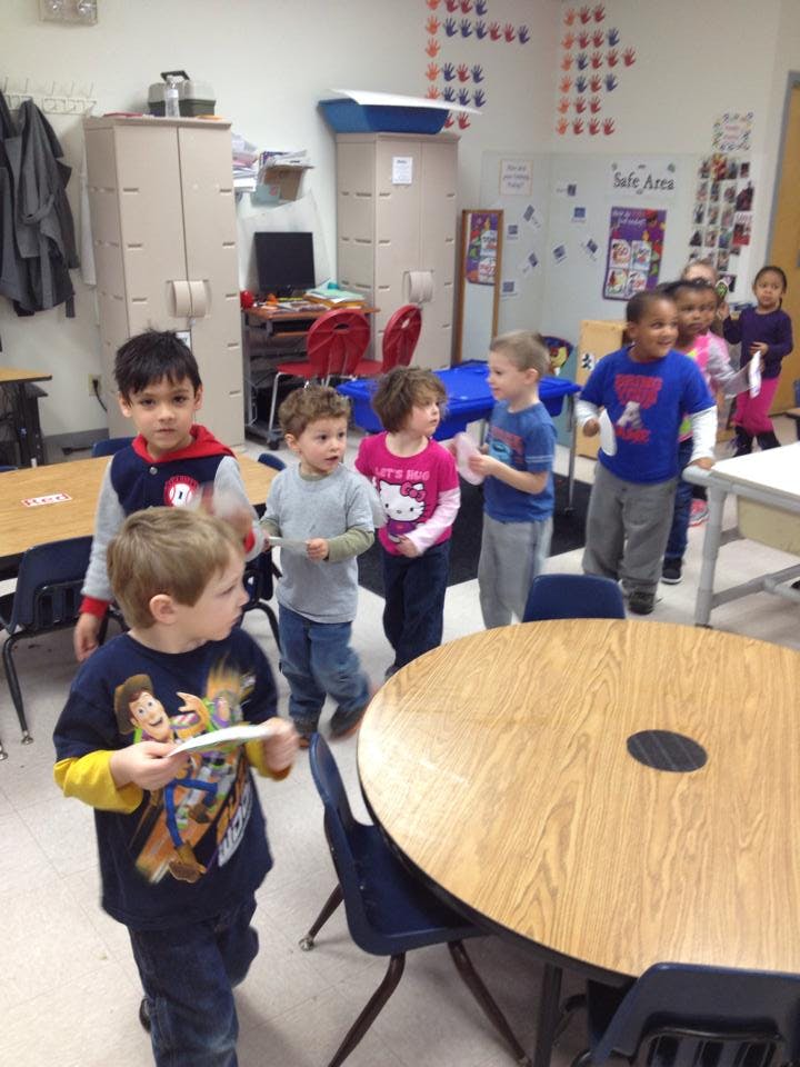 Children standing in a classroom