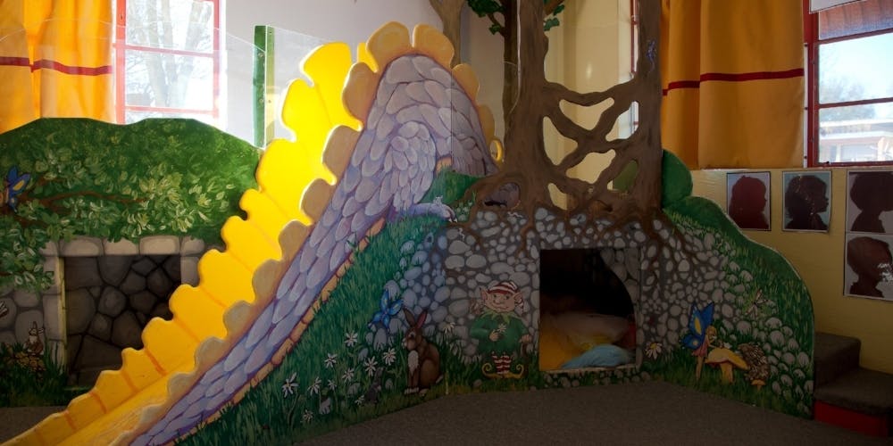 Indoor playground with a slide and a tree-like structure
