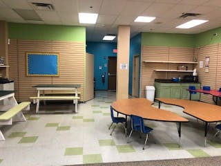 Empty classroom with tables and benches