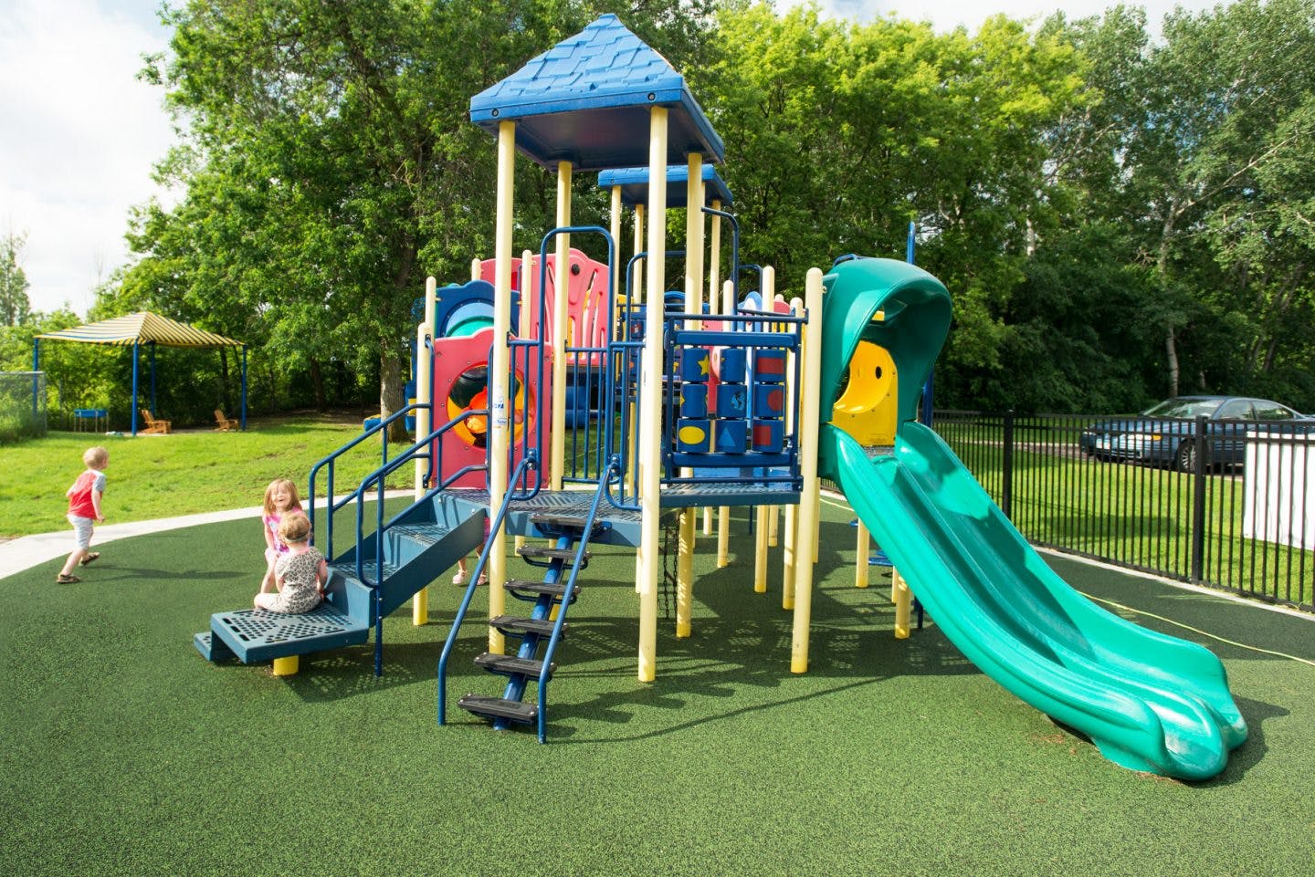 Children playing on a playground structure with a slide