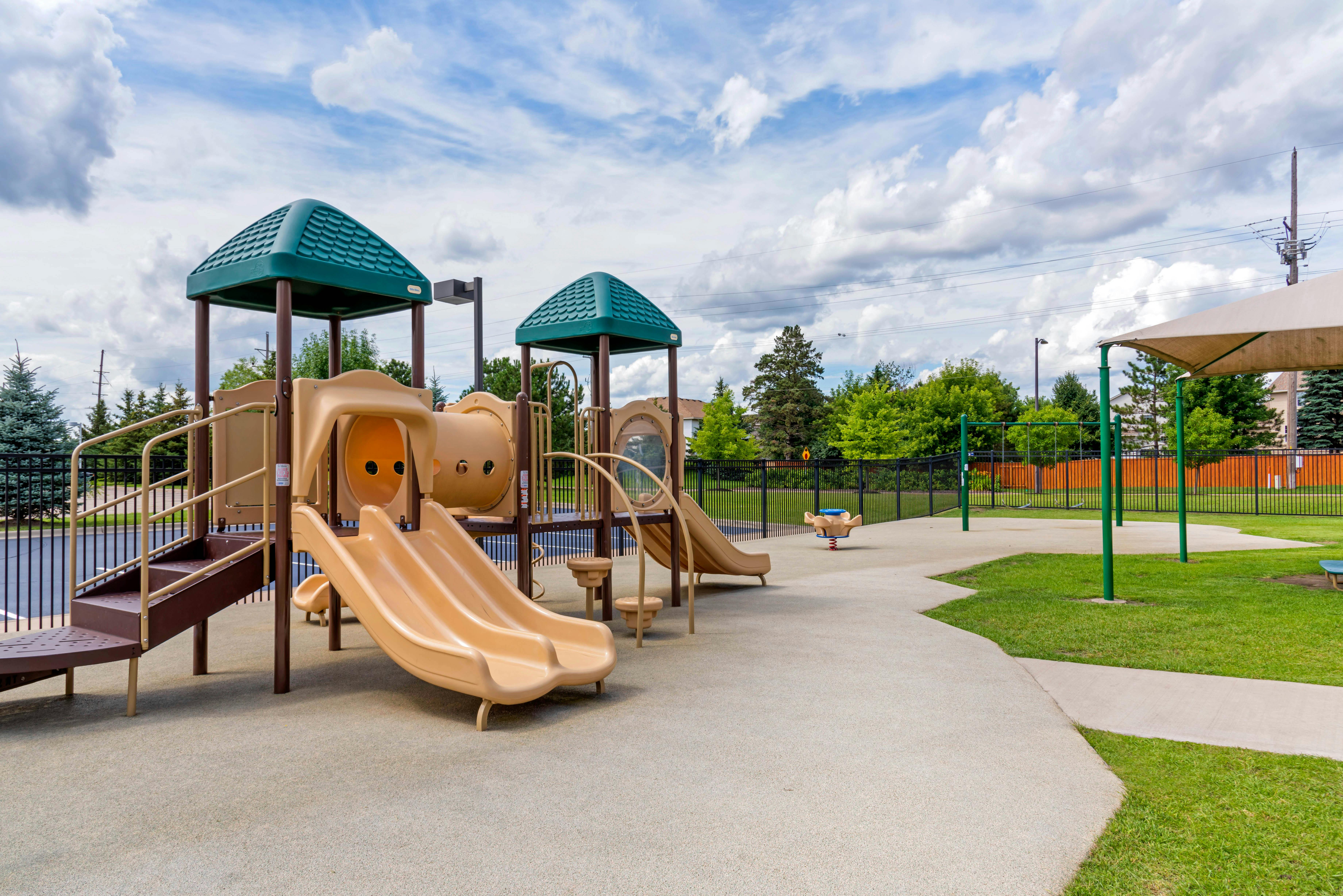 Empty children's playground with slides, tunnels, and swings