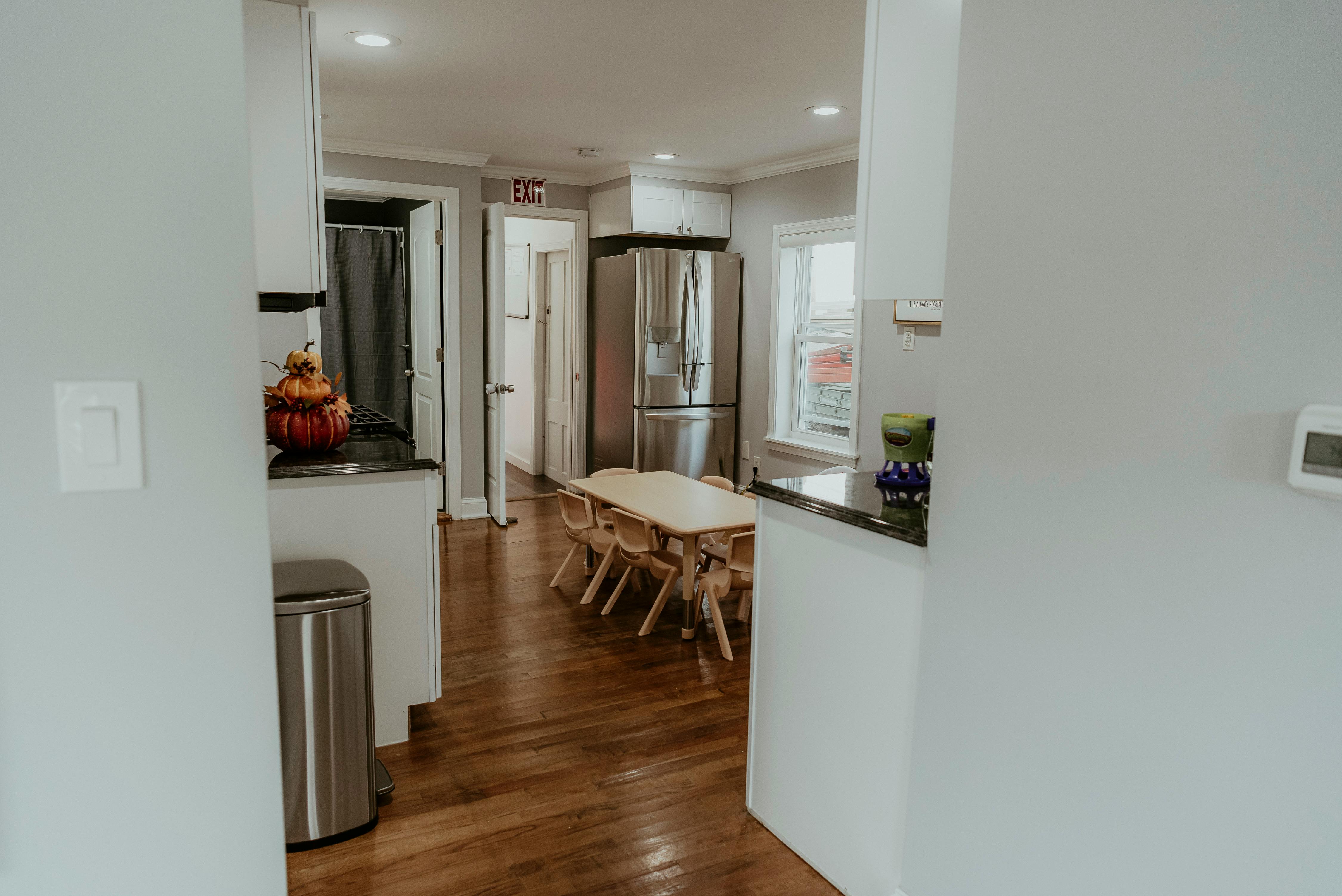 Kitchen with stainless steel appliances and a dining table