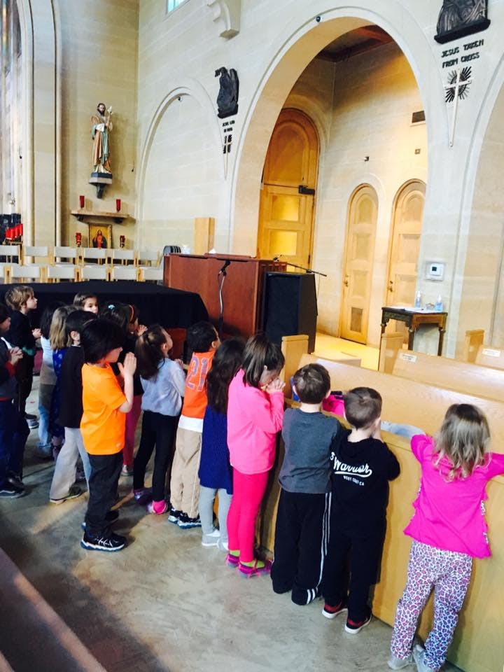 Children standing in a line in a church