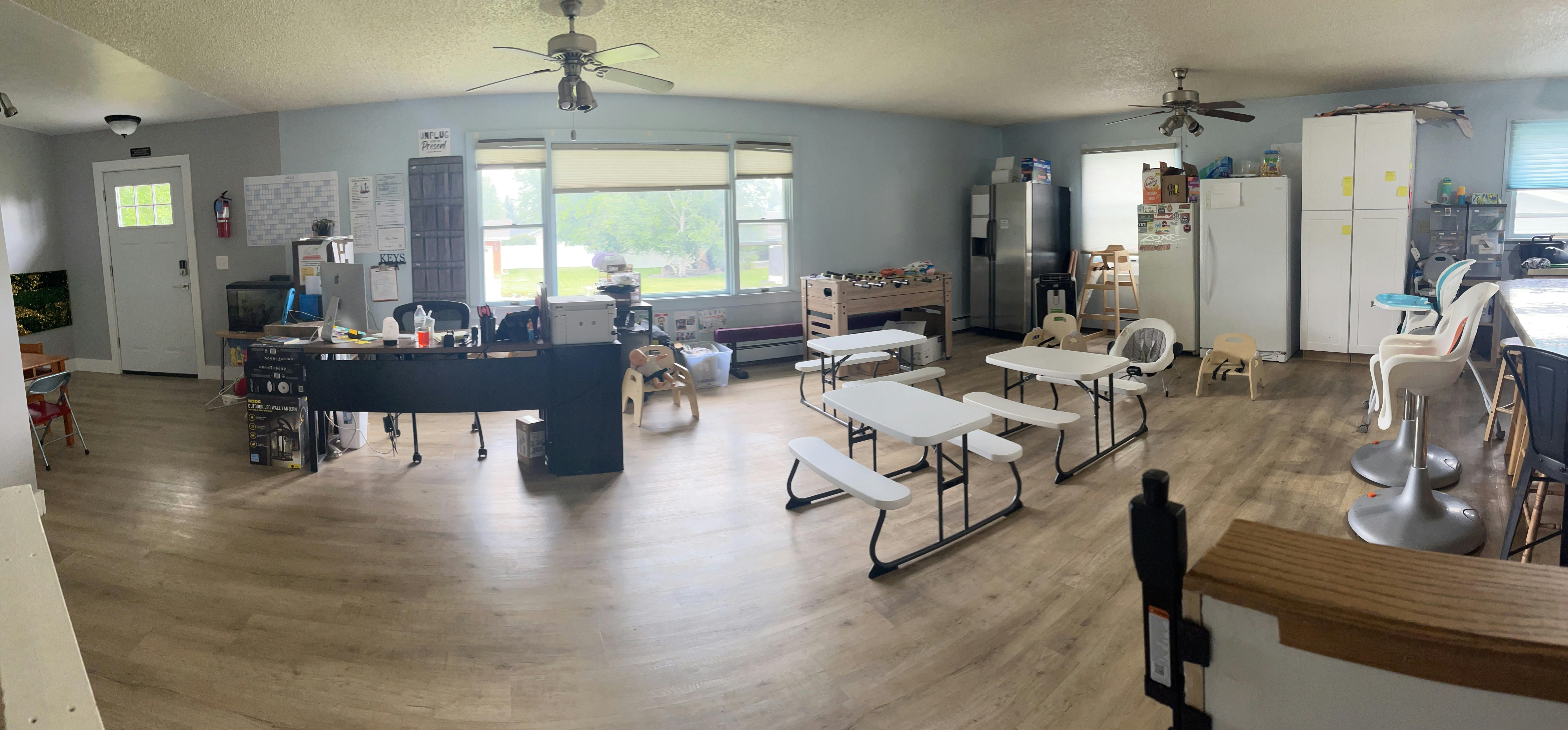 Room with tables, chairs, and a desk