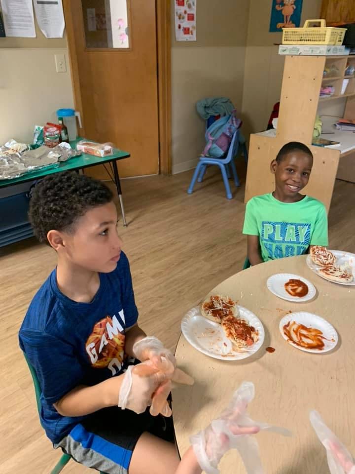 Two children at a table with plates of food