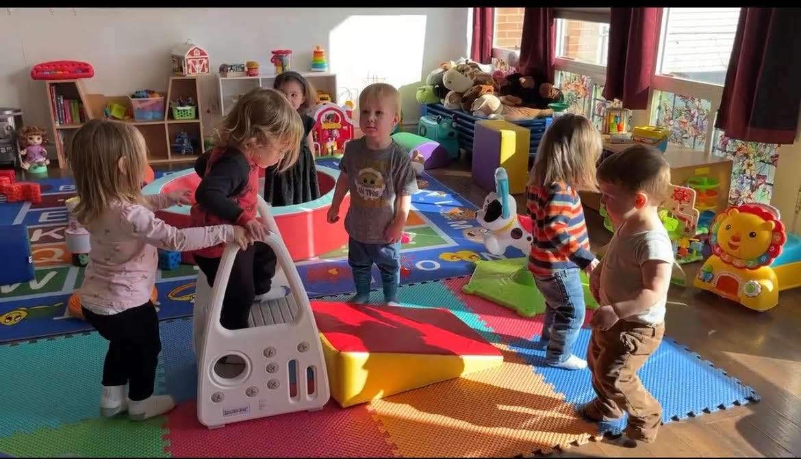 Children playing with toys in a classroom