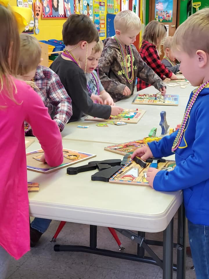 Children playing with puzzles at a table