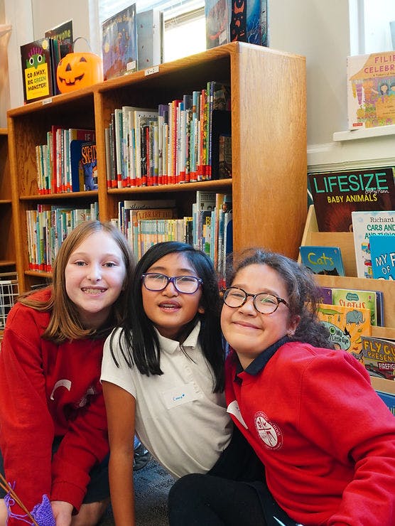 Three children in a library