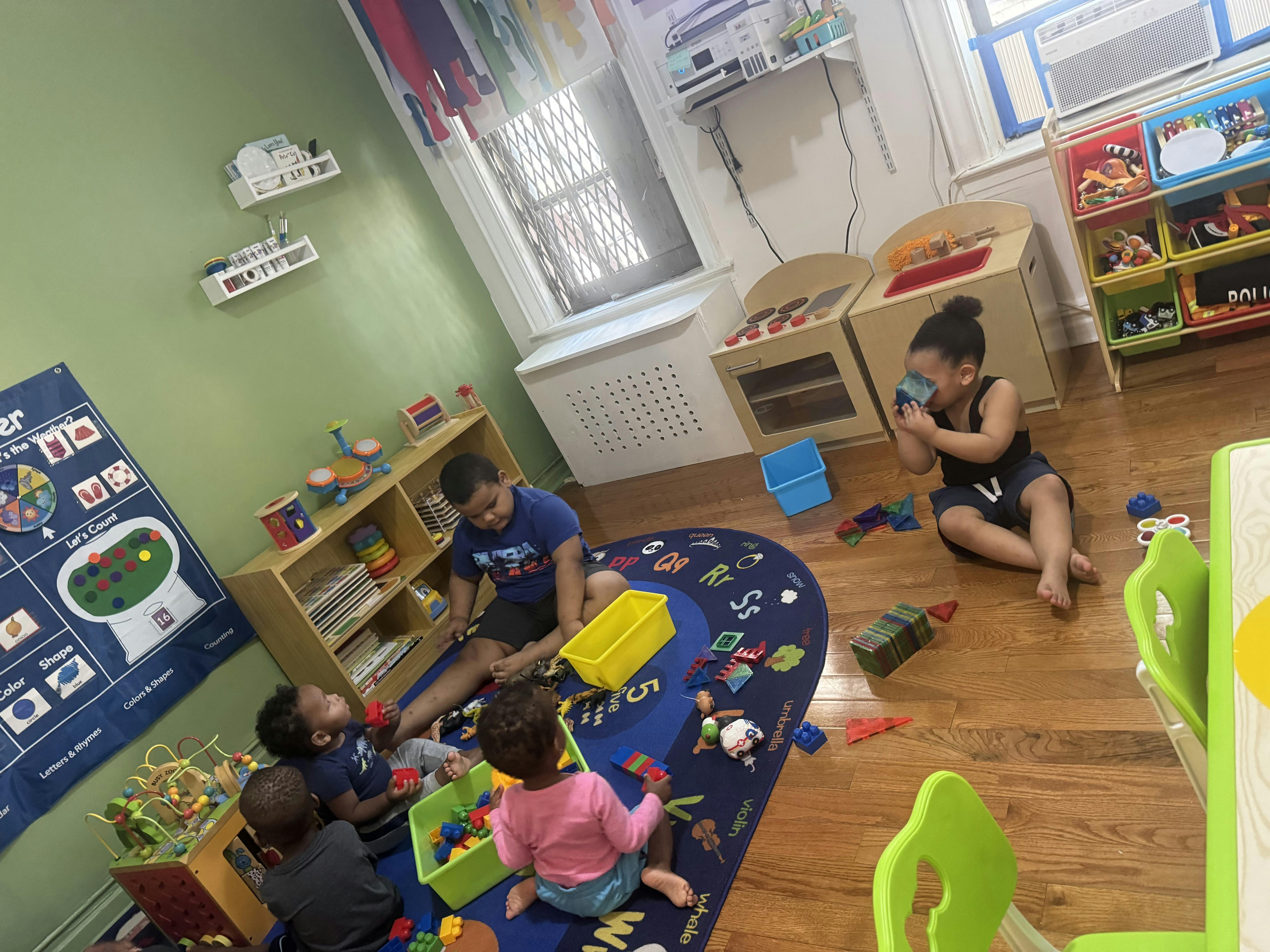 Children playing with blocks on a classroom rug