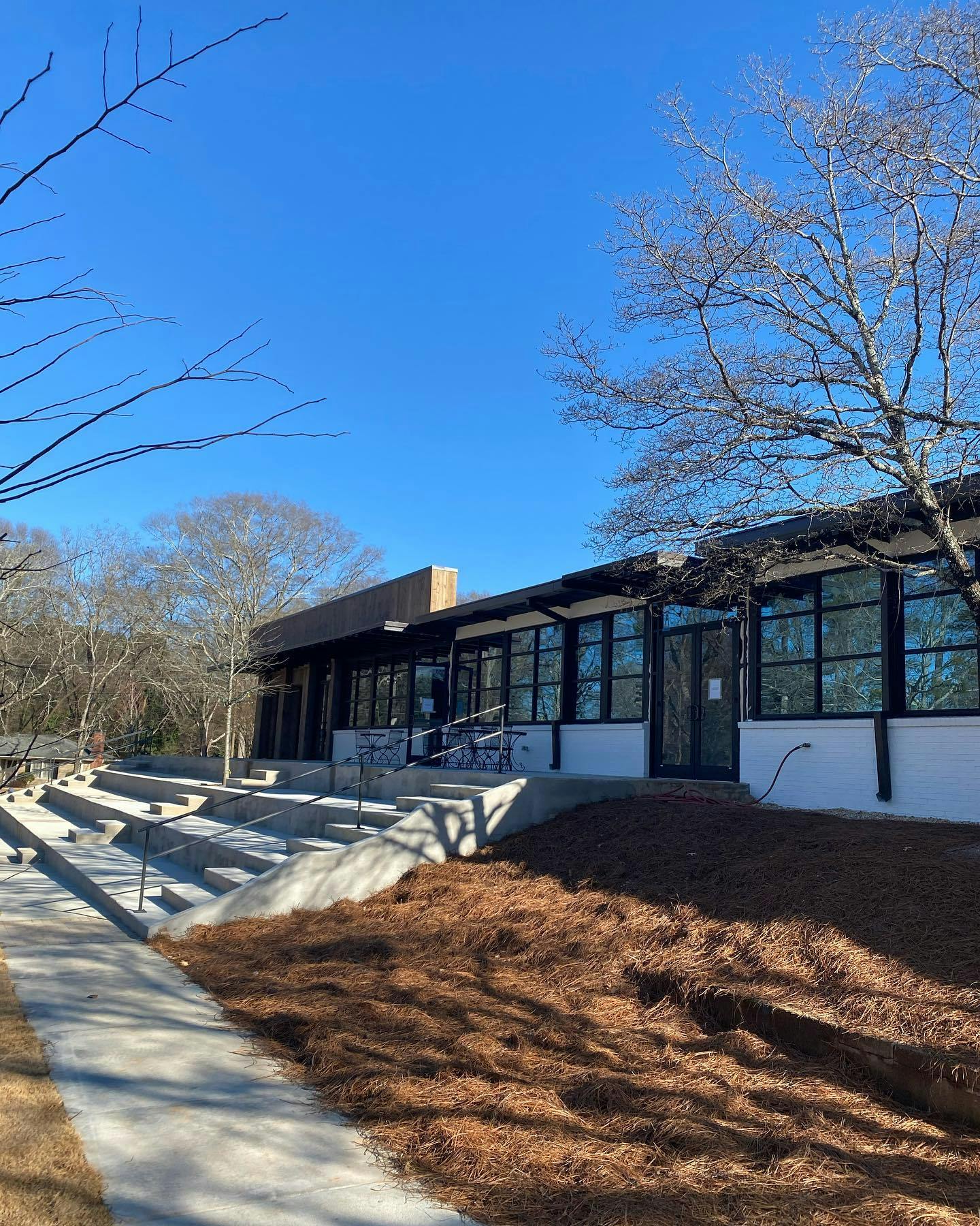 Building with large windows and outdoor concrete seating