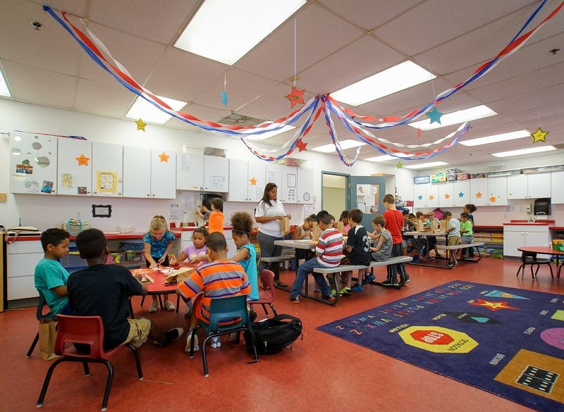 Adults and children in a classroom
