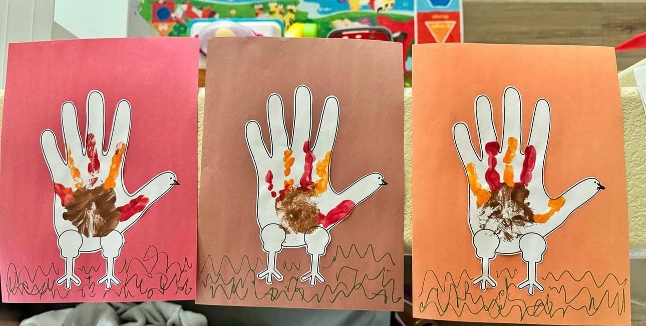 Three handprint turkey crafts on different colored paper