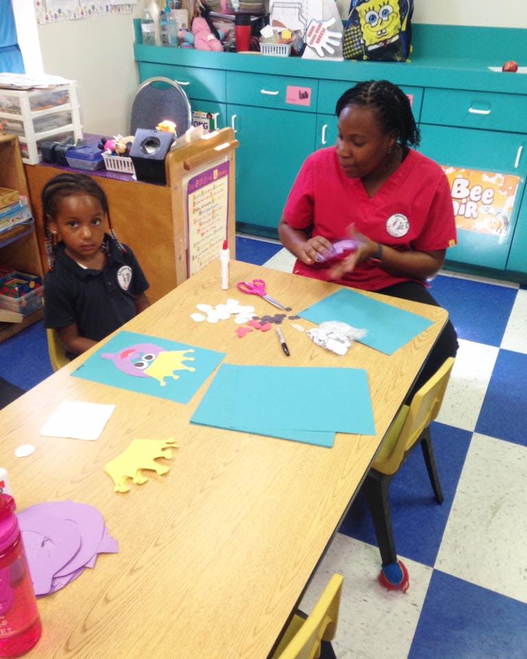 Adult and child at a table with craft supplies