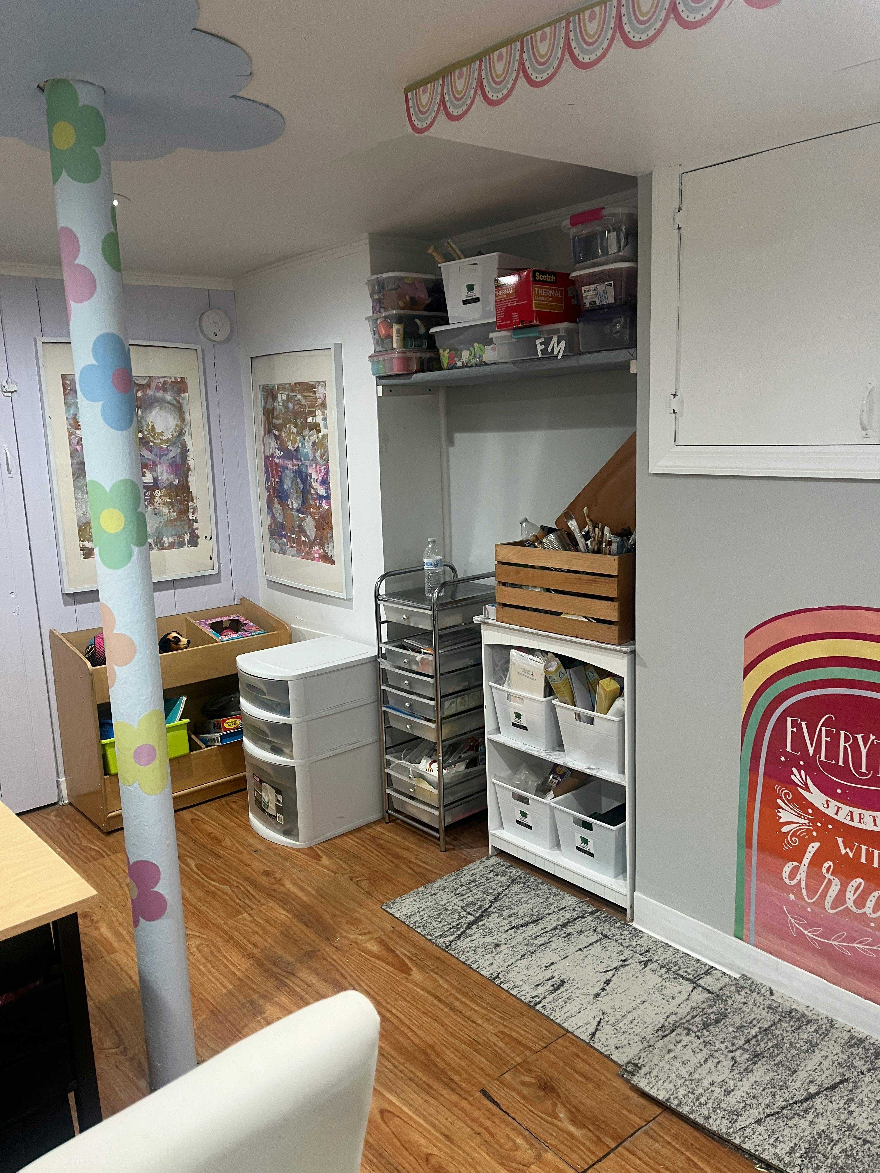 Room with storage shelves, bins, and a decorative pillar