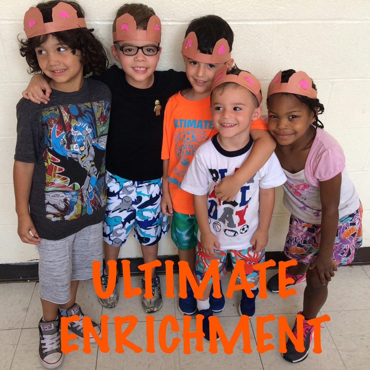 Five children wearing paper crowns standing together