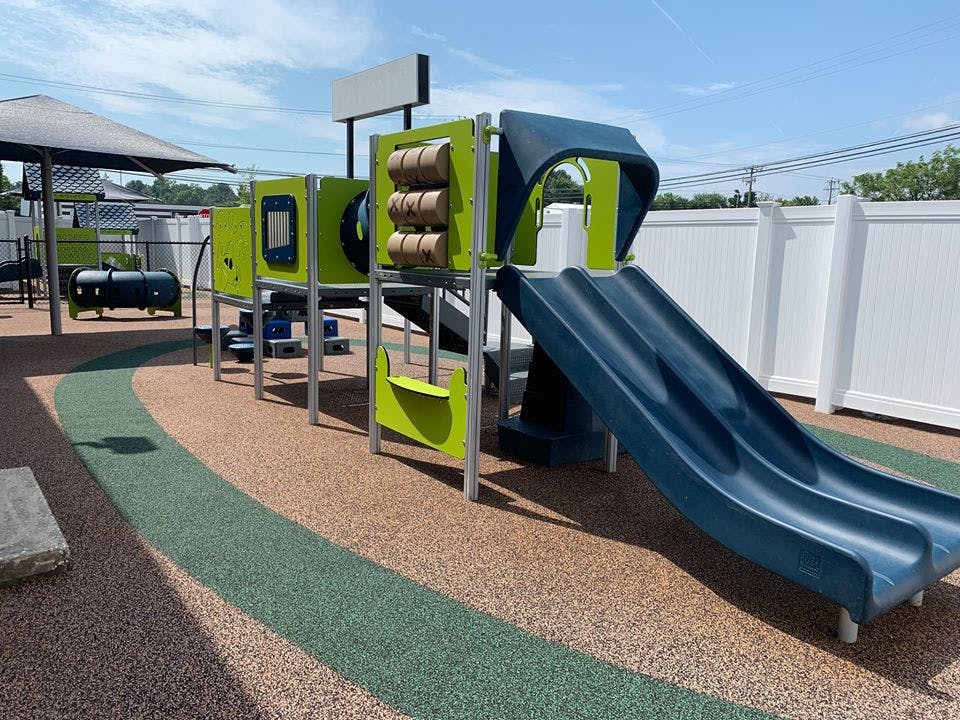 Playground structure with slides and climbing elements